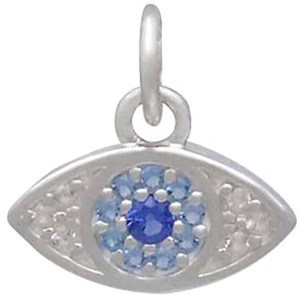 The Sterling Silver Pave Set Nano Gem Eye pendant by Nina Designs features a central dark blue gem, lighter blue nano gem pavé, and white stones on each side, all set in sterling silver with a circular loop.