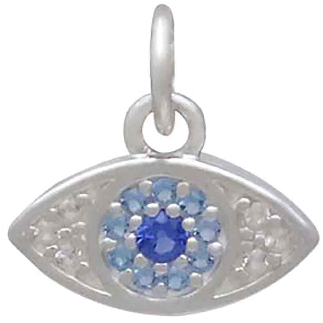 The Sterling Silver Pave Set Nano Gem Eye pendant by Nina Designs features a central dark blue gem, lighter blue nano gem pavé, and white stones on each side, all set in sterling silver with a circular loop.