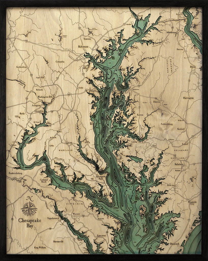 The WoodChart Chesapeake Bay 24.5" x 31" map features engraved waterways, towns, and cities in the Chesapeake Bay area, with greenish-blue water accents on a light wood background, all set in a sleek black frame.