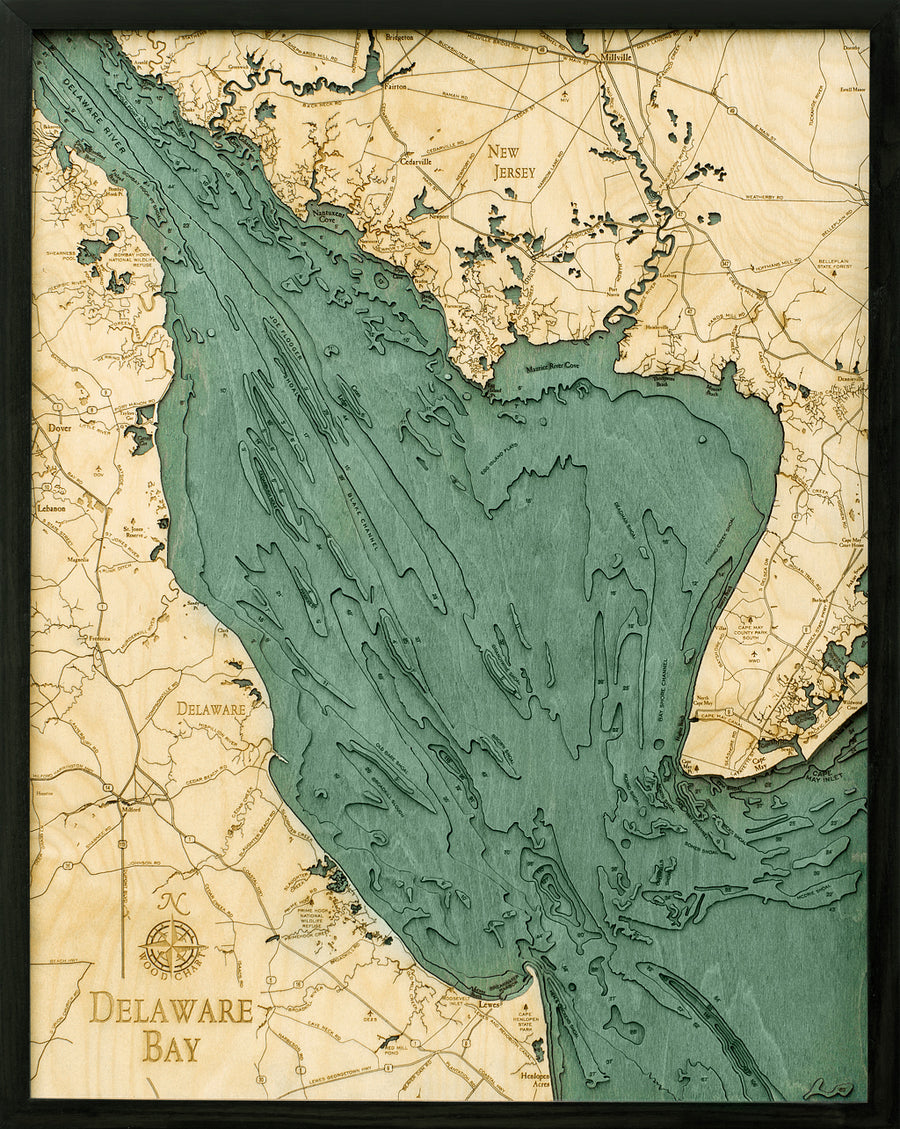 WoodChart’s Delaware Bay 24.5 x 31 Black Frame map features detailed water depth contours in blue-green, labeled regions including Delaware and New Jersey, and surrounding land over a light wood texture with a sleek black frame.