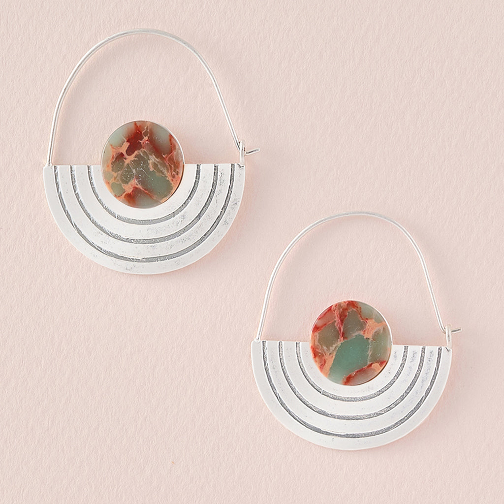 The Stone Orbit Earring Aqua Terra Silver by Scout Jewelry is a pair of sterling silver dipped hoop earrings, featuring half-moon shapes adorned with marbled red, green, and aqua terra stone accents. The half-moon sections boast parallel engraved lines, and the hypoallergenic earrings are showcased on a light beige background.