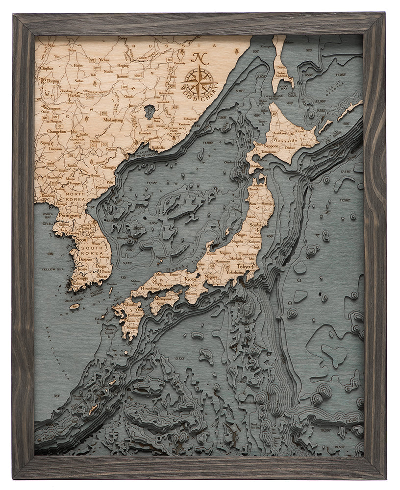 WoodChart's Japan Korea 16" x 20" Grey Frame features a layered wood map of Japan, nearby islands, and parts of Korea and China with lighter wood landmasses and dark, textured ocean details.