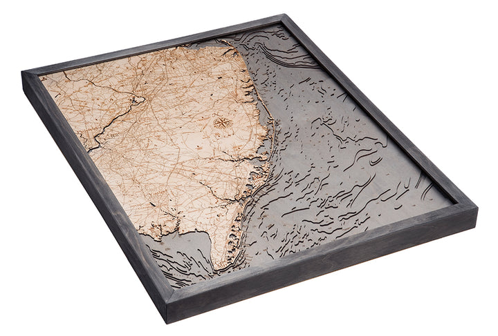 The WoodChart NJ Full Shore 24.5 x 31 Grey Frame is a framed, 3D wooden map detailing New Jersey’s coastline, roads, and terrain with finely engraved water and land features.