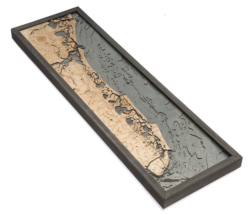 The WoodChart NJ South Shore 13.5" x 43" framed wooden relief map features the coastline, land, and underwater topography in beige and gray tones within a stylish grey frame.