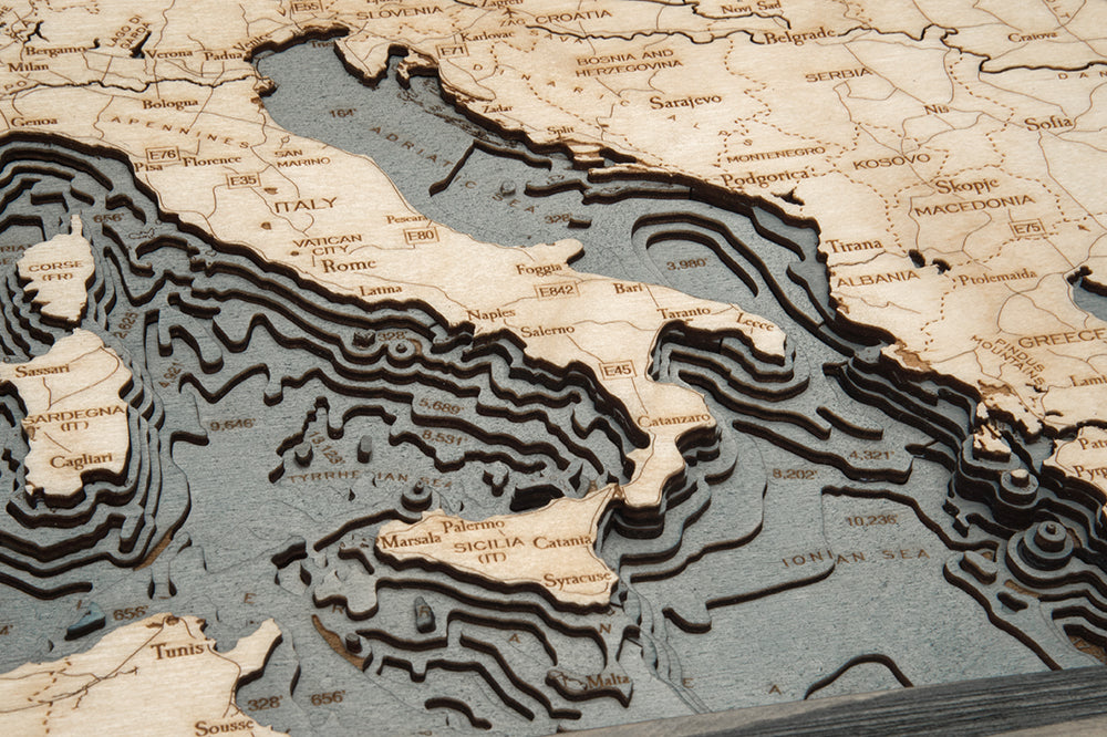 A close-up of the WoodChart Western Europe Chart (24.5" x 31", Grey Frame), featuring Italy’s boot shape, layered sea contours, and labeled cities like Rome, Naples, and Palermo.