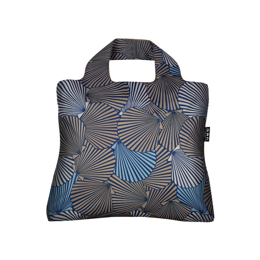 The Envirosax Mallorca Bag 2 is a square tote with a cut-out handle, showcasing overlapping blue and brown striped fan shapes on a dark backdrop—a reusable, modern bag for stylish grocery trips.