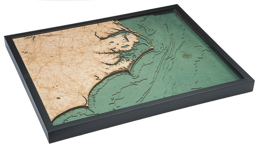 The WoodChart North Carolina Coast 24.5" x 31" Black Frame features a layered wood map highlighting detailed land and sea features along North Carolina’s coastline in natural and green tones.
