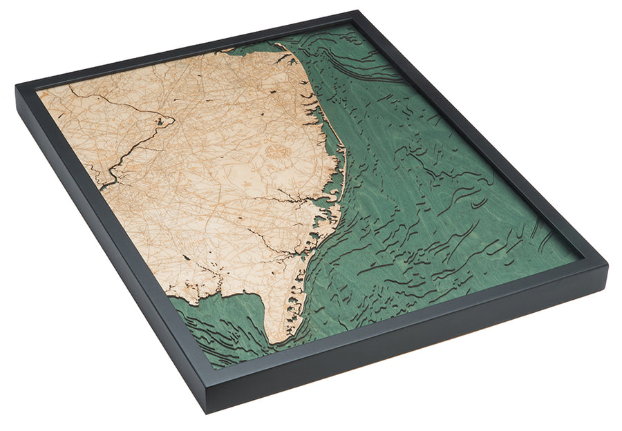 The WoodChart NJ Full Shore 24.5 x 31 Black Frame is a layered wooden map featuring the New Jersey coast, with detailed land in light wood and textured blue-green ocean, accentuating shoreline contours and inland roads.