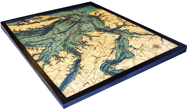 The WoodChart Norfolk VA 24.5 x 31 Black Frame is a framed, 3D topographic map with land in light tan and water in blue and green shades, highlighting detailed coastlines and elevation changes.