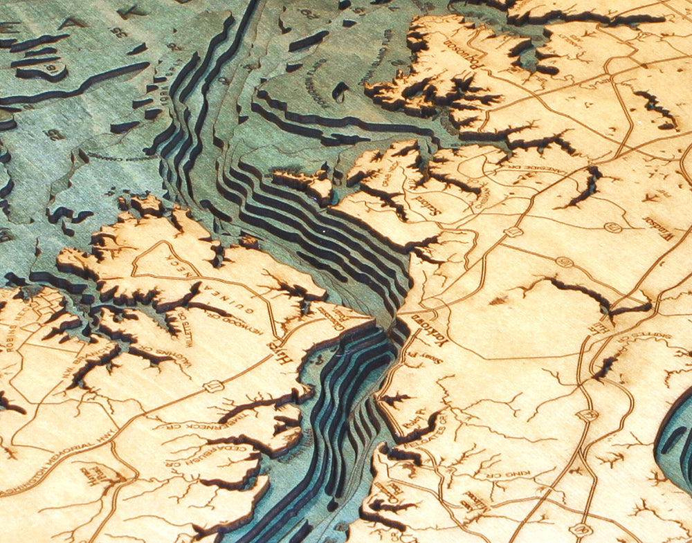 WoodChart's Norfolk VA 24.5 x 31 Black Frame features a wooden map with laser-etched contour lines, labeled roads, towns, water in blue-green, and tan land—all in a detailed, artistic style.