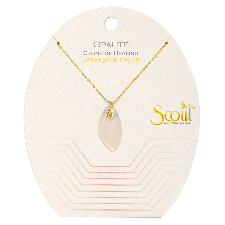 The Opalite Gold Organic Stone Necklace by Scout Jewelry features a 14k gold chain with an opalite gemstone pendant. It is presented on a white card that reads "Opalite Stone of Healing" and "Scout Curated Wears," along with the necklace length of 16" + 2" adjustable. A geometric pattern adorns the bottom of the card.