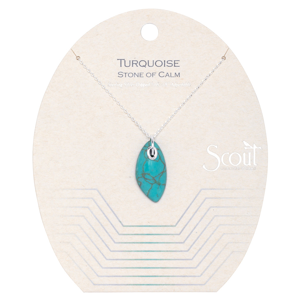 The Turq Silver Organic Stone Necklace, featuring a turquoise gemstone pendant, is elegantly showcased on a card inscribed with "Turquoise, Stone of Calm." The card displays Scout Jewelry's branding in the corner and boasts a minimalist design adorned with geometric lines.