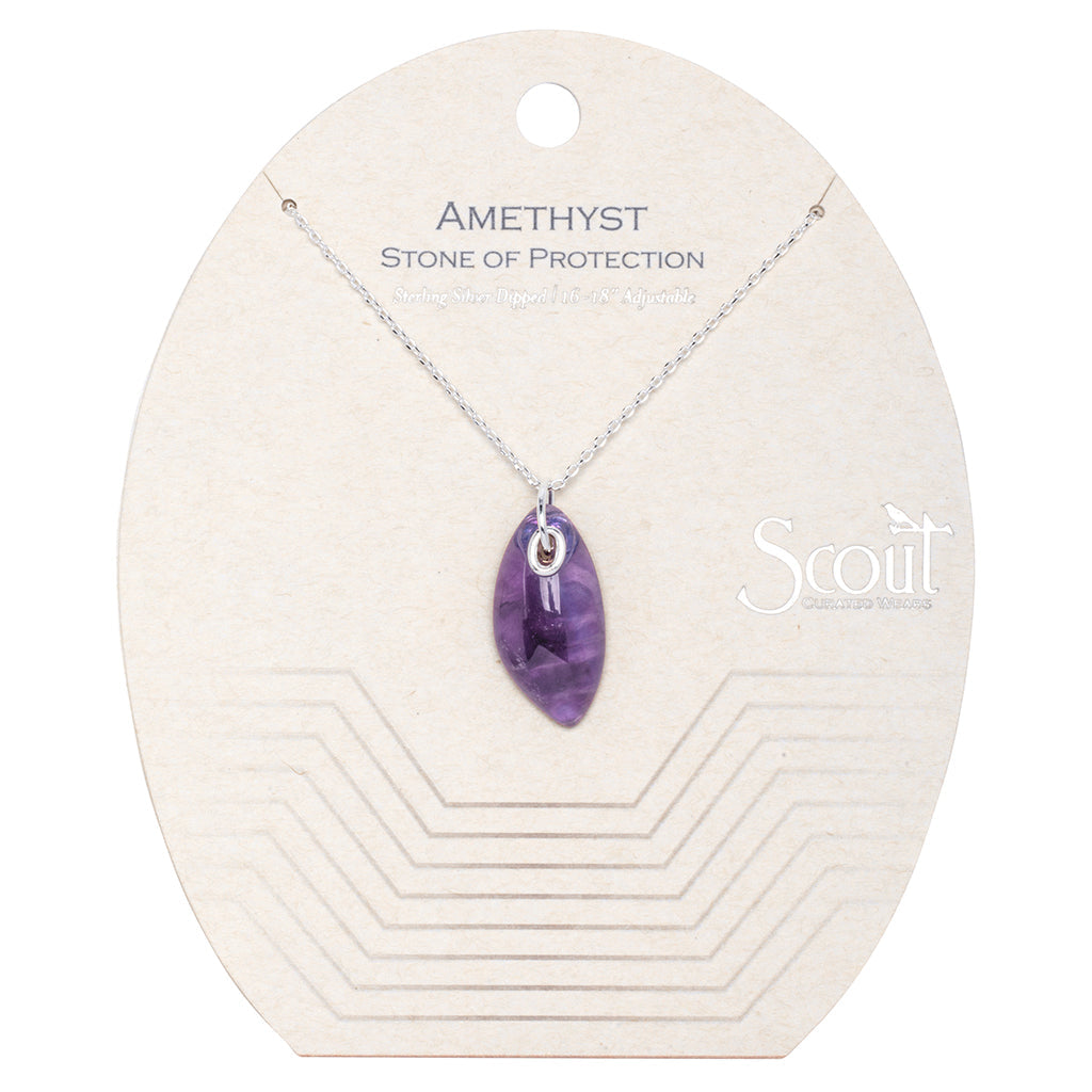 The Amethyst Silver Organic Stone Necklace from Scout Jewelry showcases a stunning amethyst pendant suspended on a sterling silver chain. The necklace is elegantly presented on a beige backing card adorned with geometric line designs and the phrase "Amethyst Stone of Protection." The word "Scout" is subtly displayed on the right side, enhancing its sophisticated appeal.