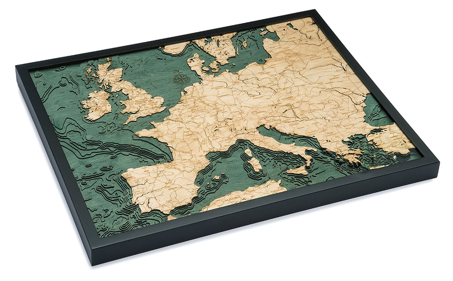The WoodChart Western Europe Chart (24.5" x 31") features a 3D wooden topographic map in a black frame, with land in light wood, water in green, and visible elevation contours and country borders, displayed at a slight angle.