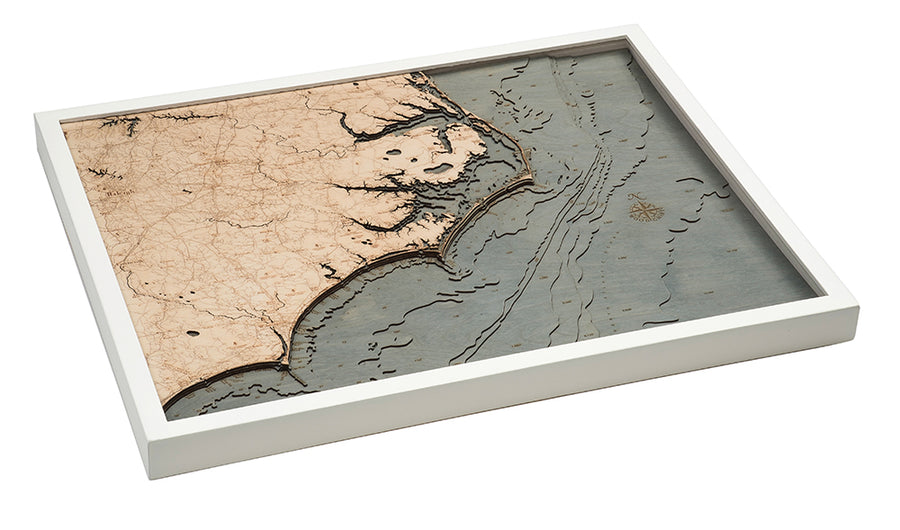The WoodChart North Carolina Coast 24.5" x 31" map features engraved topographic and road details of the coastline and inland areas, set in a layered wood design with a white frame.