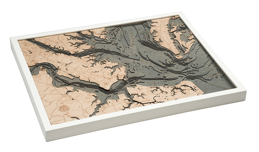 The WoodChart Norfolk VA 24.5 x 31 White Frame showcases a layered wooden topographic map of river systems and landforms, using light and dark wood to highlight elevation within a sleek white frame.