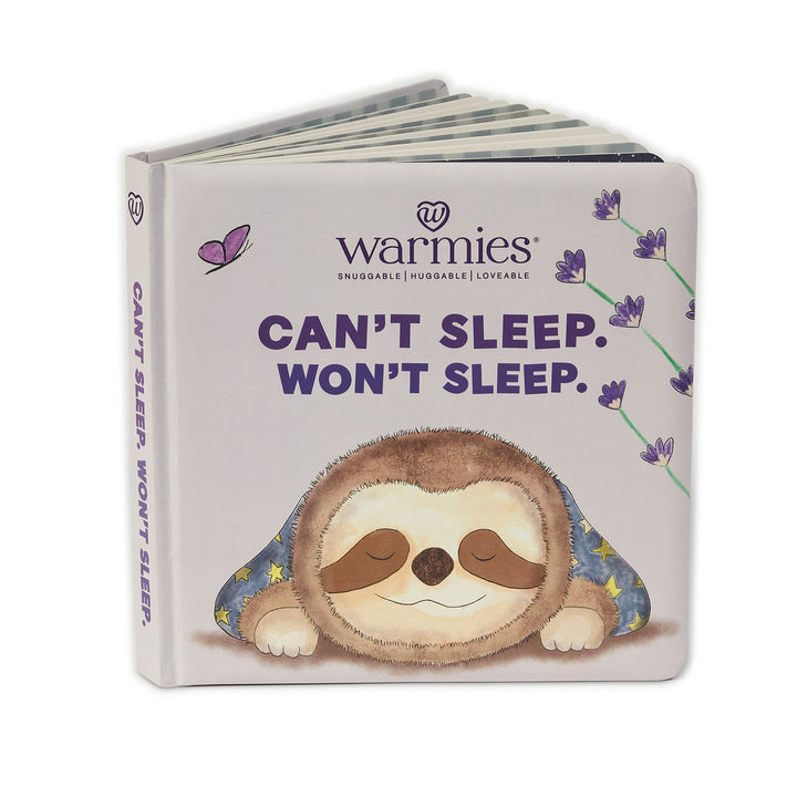 The children's book "Can`t Sleep Won`t Sleep" by Warmies features a cozy illustration of a pajama-clad sleeping sloth in Lavender Land with soothing lavender and a butterfly. The cover highlights "Warmies Books" with the phrase "Snuggable | Huggable | Loveable," promising a bedtime hug.