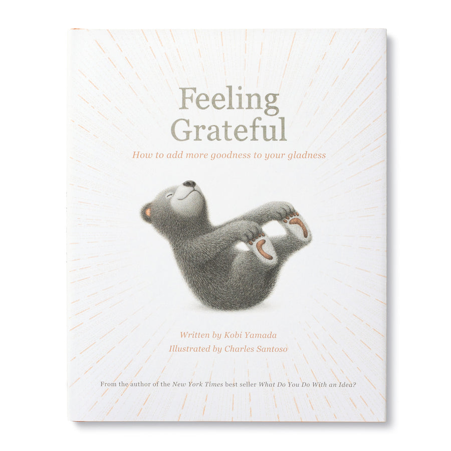 The cover of the children's book "Feeling Grateful" is displayed, showcasing an illustration of a content-looking bear lying on its back. This self-improvement book by Kobi Yamada, published under the Compendium brand and illustrated by Charles Santoso, teaches the value of gratitude.