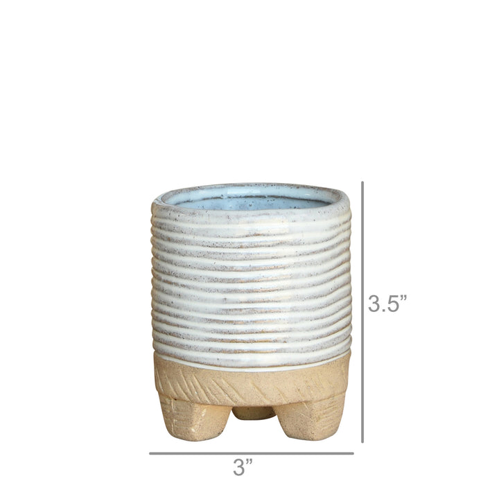 Introducing the Horizontal Stripe Cachepot by HomArt, a petite 3.5-inch tall ceramic planter with elegant ribbed detailing on its light gray upper half and a textured tan base that mimics hand-sculpted designs. Its 3-inch diameter is supported by three short legs, and the smooth light blue interior makes it perfect for indoor gardening enthusiasts.