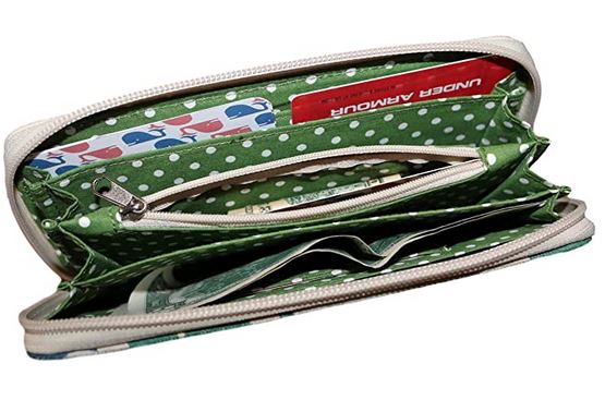 The Zipper Wallet Whale by Bungalow 360 showcases unique designs with a vibrant green polka dot interior and multiple compartments. It easily accommodates a red Under Armour card and numerous paper currency notes. A central zipper pocket provides an ideal spot for organizing your essentials.