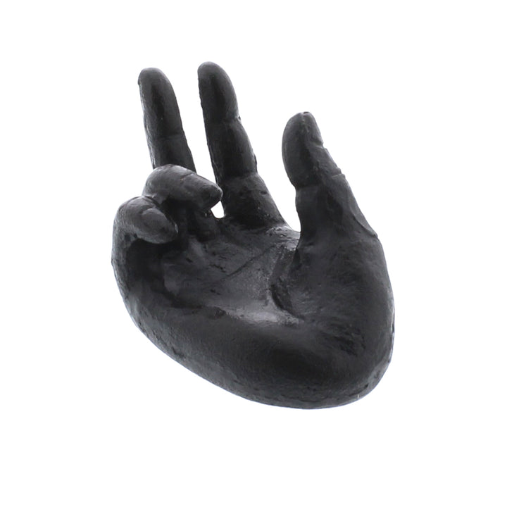 The Single Hand Card Holder - Antique Black from HomArt, with its sculpted zen hand design featuring a forward-facing palm and slightly curled fingers, exudes calm and serenity against a stark white background. Its sturdy presence invites contemplation and tranquility.