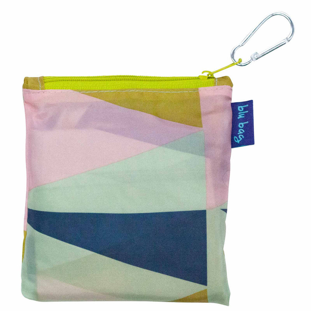 Introducing the Zuri Reusable Bag from zzzRockFlowerPaper: a chic, colorful geometric-patterned zipper pouch featuring a convenient yellow zip and a small carabiner for easy attachment. It includes a blue tag with text on the side and showcases pastel shades of pink, blue, green, and yellow. Ideal for storing essentials in an environmentally friendly manner.
