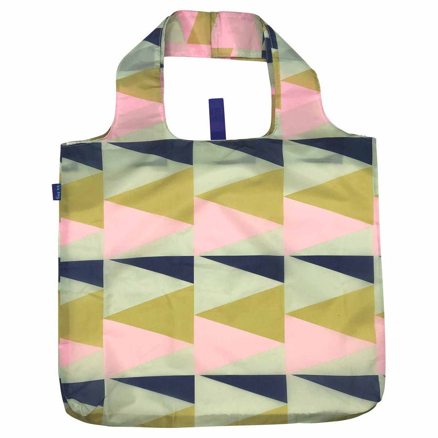 The Zuri Reusable Bag by zzzRockFlowerPaper is both stylish and eco-friendly, featuring a geometric design with overlapping triangles in pink, green, and navy shades. It comes with a convenient handle and has a small blue tag on the side, combining practicality with chic aesthetics.
