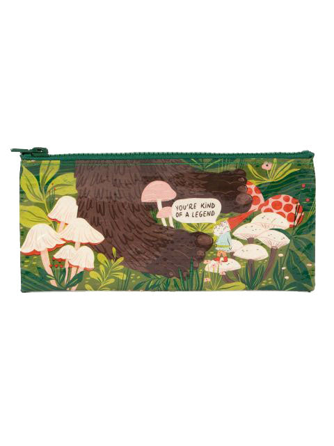 Introducing the "Kind of a Legend" pencil case by Blue Q—a charming and eco-friendly accessory crafted from Post Consumer Recycled Material. This green pencil case showcases a whimsical illustration of a large, brown hairy creature holding a sign that reads, "You're Kind of a Legend." The enchanting design is completed with an array of mushrooms and foliage, perfectly capturing the vibe of an enchanted forest.