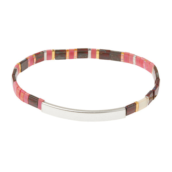 The Miyuki Joy and Kindness Mulberry Silver bracelet by Scout Jewelry features alternating pink, red, brown, and orange rectangular beads with a Sterling silver dipped bar—a chic twist on classic Japanese glass Miyuki styles.
