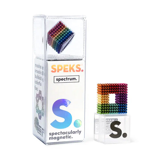 A compact box of 512 Rainbow Spectrum Speks from the SPEKS brand, showcasing magnetic balls in cube form with vibrant rainbow colors. The packaging highlights the brand name "SPEKS" and the phrase "S. spectacularly magnetic," both adorned with a holographic design. Perfect for crafting Mash Speks geometric shapes, the cube enticingly emerges from the box.