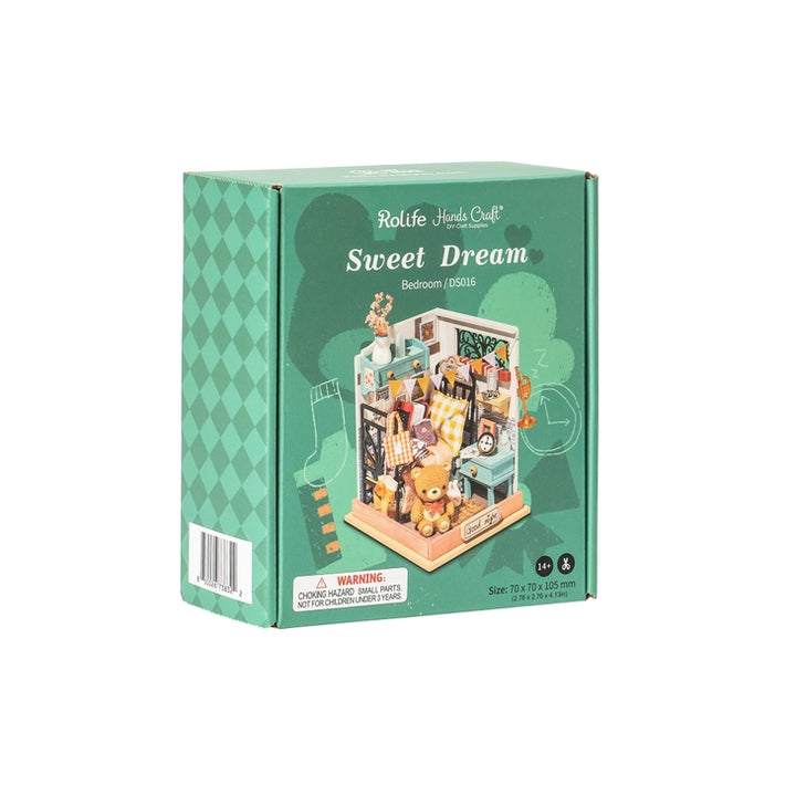 Box for the "Hands Craft: Bedroom DIY Micro Miniature Kit." The front image showcases an assembled miniature bedroom with various tiny objects. The green and white packaging highlights this detailed crafting set while warning about small parts posing a hazard to children under 3.