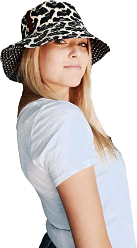 A person with long blonde hair, wearing a light blue shirt and a stylish Beach Hat Bat by Bungalow 360 in black-and-white leopard print, looks confidently at the camera against a plain white background.
