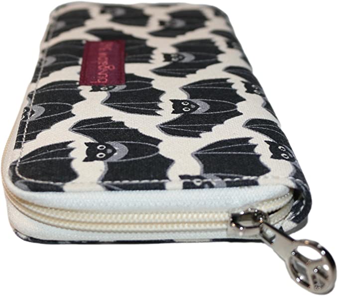 The Zipper Wallet Bat by Bungalow 360, crafted from cotton canvas and decorated with a distinctive pattern of black bats on a white background, is an ideal choice for animal and pet enthusiasts. It includes a metallic zipper pull and a fabric tag near the zip, combining style with practicality.