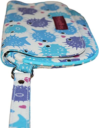 Close-up of a Large Wristlet Puffer Fish by Bungalow 360, crafted from vegan cotton canvas with a whimsical blue and purple puffer fish print. It features a wrist strap and has a label on the front, showcasing unique designs in a playful, cartoonish pattern on a light background.