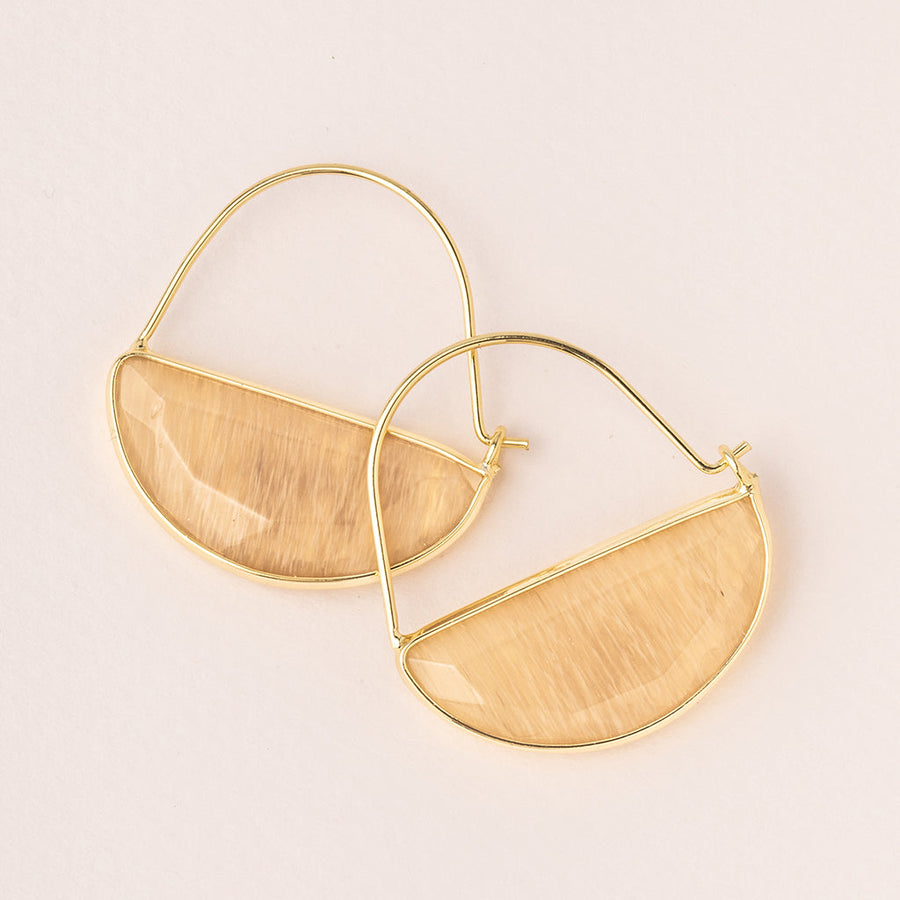 The Hoop Earring Citrine/Gold from Scout Jewelry features a semi-circular design with a beige, wood-like texture. Hypoallergenic and elegant, these minimalist earrings are perfect for sensitive skin, beautifully displayed on a light neutral background.