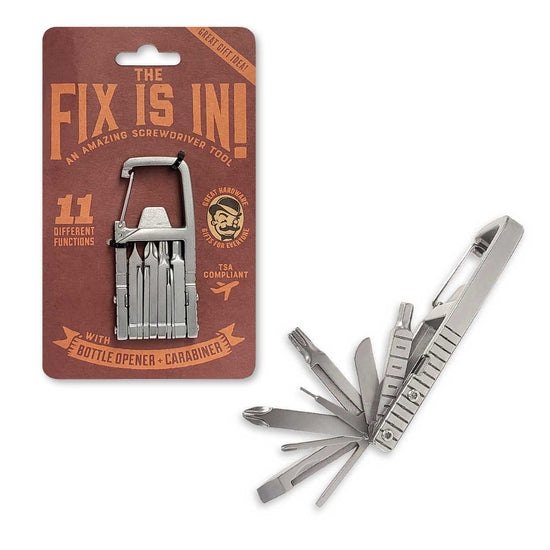 A multi-functional, stainless steel tool with metallic attachments, featuring screwdrivers, a ruler, and a bottle opener, is displayed unfolded alongside its packaging. The packaging is labeled "The Fix is In Carabiner" from TrixienMilo and highlights 11 different functions.