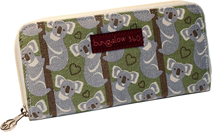 Introducing the Zipper Wallet Koala from Bungalow 360, a rectangular vegan wallet with a zipper. This delightful design features a distinctive koala pattern set against a backdrop of green leaves and brown tree branches, complete with multiple koalas and small hearts to enhance the charm. A red "bungalow 360" label is prominently stitched on the front, highlighting its commitment to supporting animal causes.