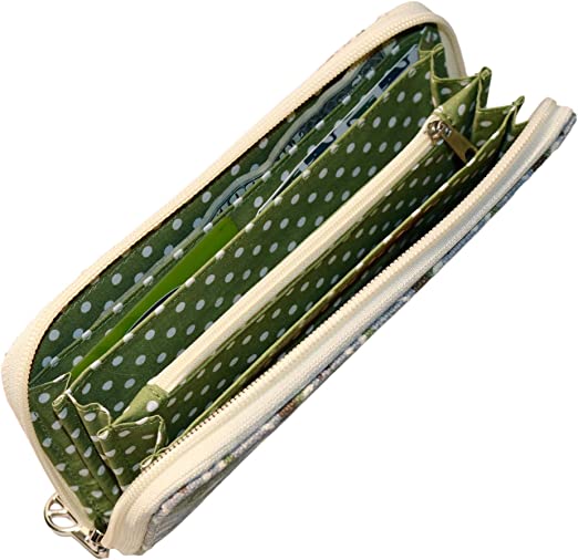 The Zipper Wallet Koala by Bungalow 360 features an open design that displays a green polka dot interior complete with multiple compartments and zippers. This vegan wallet's exterior is adorned with unique floral designs and, when unzipped, reveals a spacious interior perfect for organizing cards and cash, making it ideal for anyone passionate about animal causes.