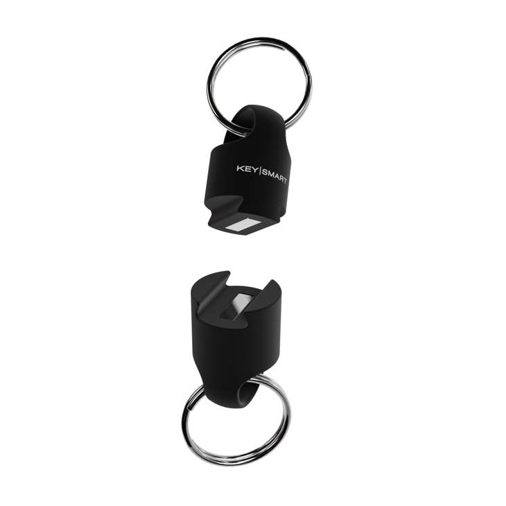 The Magnetic Quick Connect Pro by KeySmart is a black keychain holder consisting of two ultra-durable pieces, each equipped with a keyring. The top piece features the "KeySmart" logo, while the bottom remains plain. It includes a secure locking mechanism that allows for easy magnetic connection between the pieces.