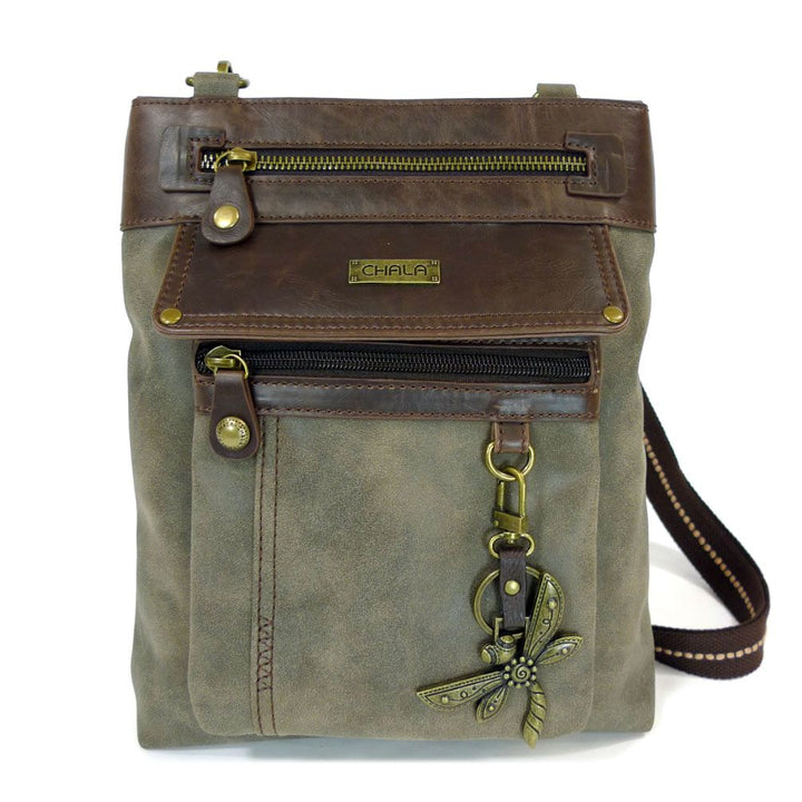 The Gemini Xbody w DF Stone Grey by Chala is a stylish crossbody bag crafted from brown leather and gray canvas. It boasts a detachable front pocket with a zipper, a larger compartment with a zip closure, and is adorned with a decorative metal dragonfly charm hanging from a loop. The bag comes with adjustable brown and black straps.