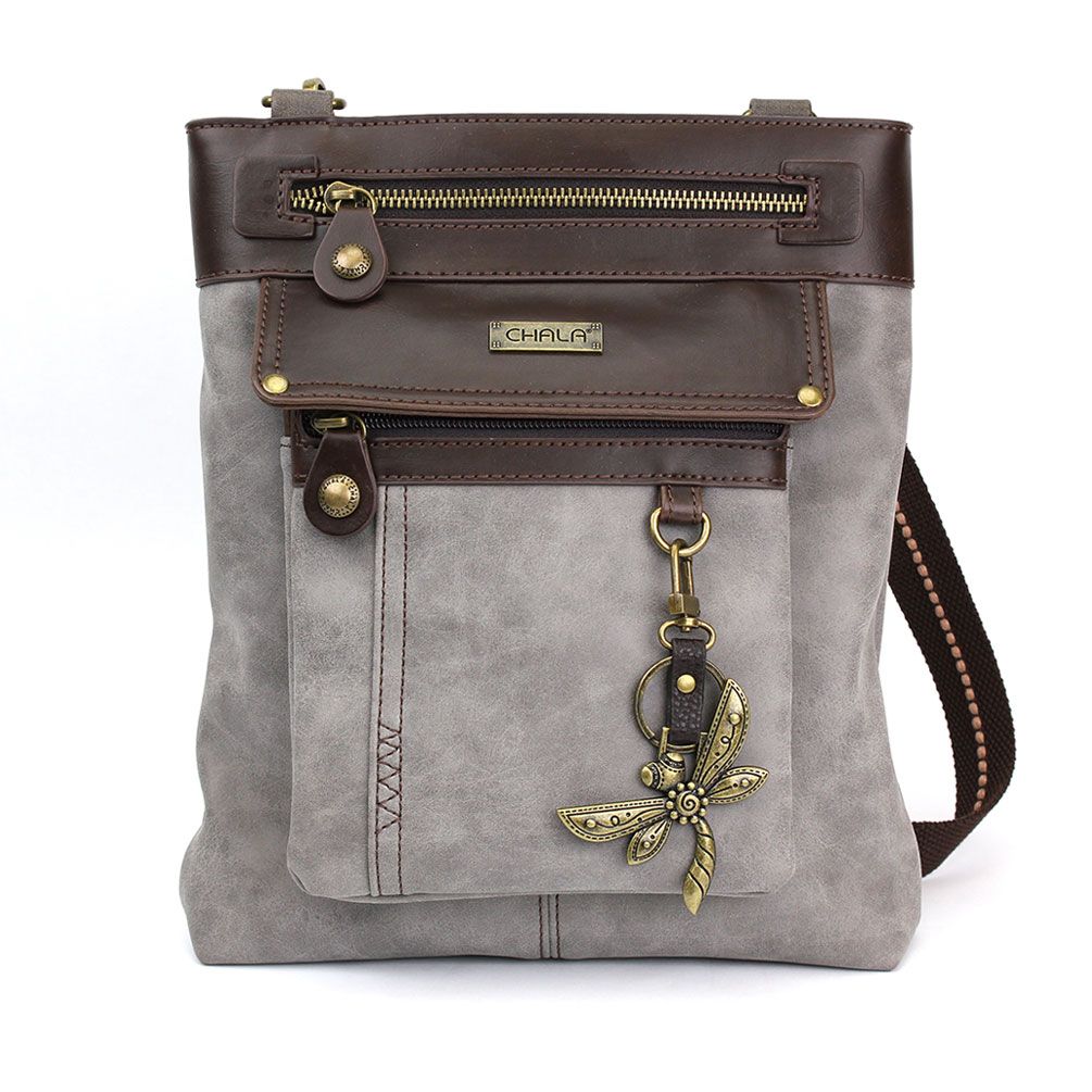 The Gemini Xbody w DF Gray by Chala is a stylish gray and brown crossbody bag adorned with a front zipper pocket and a decorative dragonfly charm. It features a leather strap with intricate stitching, brass accents, and a small metal plate showcasing the brand name "Chala" above the front pocket. Inside, you'll find smooth fabric lining for added elegance.