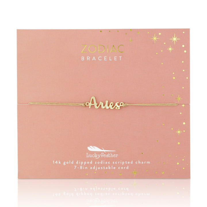 LuckyFeather's Zodiac Bracelet Aries is a delicate bracelet dipped in 14k gold, featuring "Aries" elegantly scripted. It comes on a pink card adorned with gold stars, providing details about the bracelet's material and its adjustable length for an ideal fit.