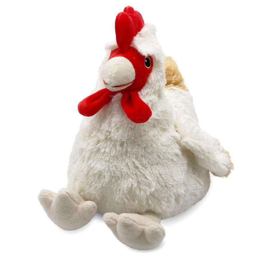 The Chicken Warmies by Warmies is a plush toy featuring a fluffy white body, a vibrant red comb and wattle, and soft beige legs. It has a cheerful expression with tucked wings and is infused with a calming lavender scent. This microwavable toy provides cozy warmth for added comfort.