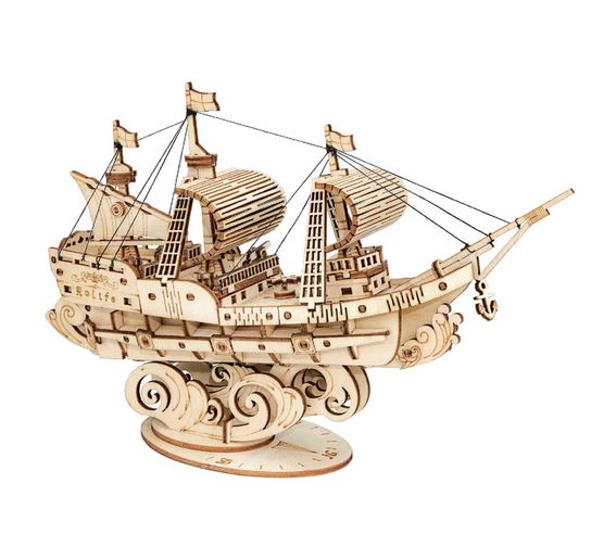 The DIY Sailing Ship by Hands Craft is a wooden model ship designed with intricate details like masts, sails, rigging, and an anchor. It is displayed on a decorative base that resembles waves. Crafted from non-toxic wood using laser-cut sheets, this model ship includes labeled components for easy assembly and appears highly detailed and realistic.