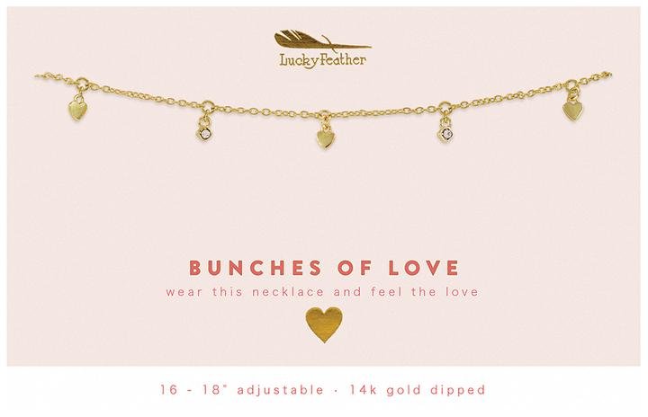 Introducing the "Dangle Necklace Love" by LuckyFeather: This exquisite necklace boasts a 14k gold-plated delicate chain adorned with charming heart accents and sparkling crystals. Adjustable from 16 to 18 inches, it’s designed to make you feel cherished every time you wear it. The text reads, "BUNCHES OF LOVE - wear this necklace and feel the love." Adorn yourself with a touch of elegance from LuckyFeather.