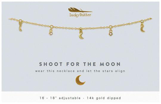 The Dangle Necklace Moon by LuckyFeather, a 14k gold dipped adjustable necklace (16 - 18 inches), features moon and star charms with the text: "SHOOT FOR THE MOON, wear this 14k gold plated adjustable necklace and let the stars align.