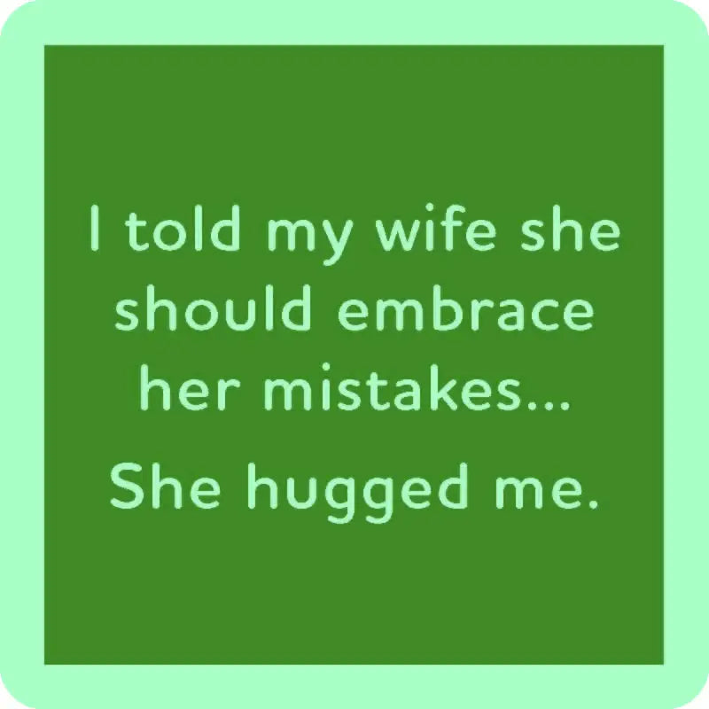 The "she hugged me" coaster by Drinks On Me features a green square design with a humorous message in white text: "I told my wife she should embrace her mistakes... She hugged me." The resin finish and cork backing add charm to this witty piece.