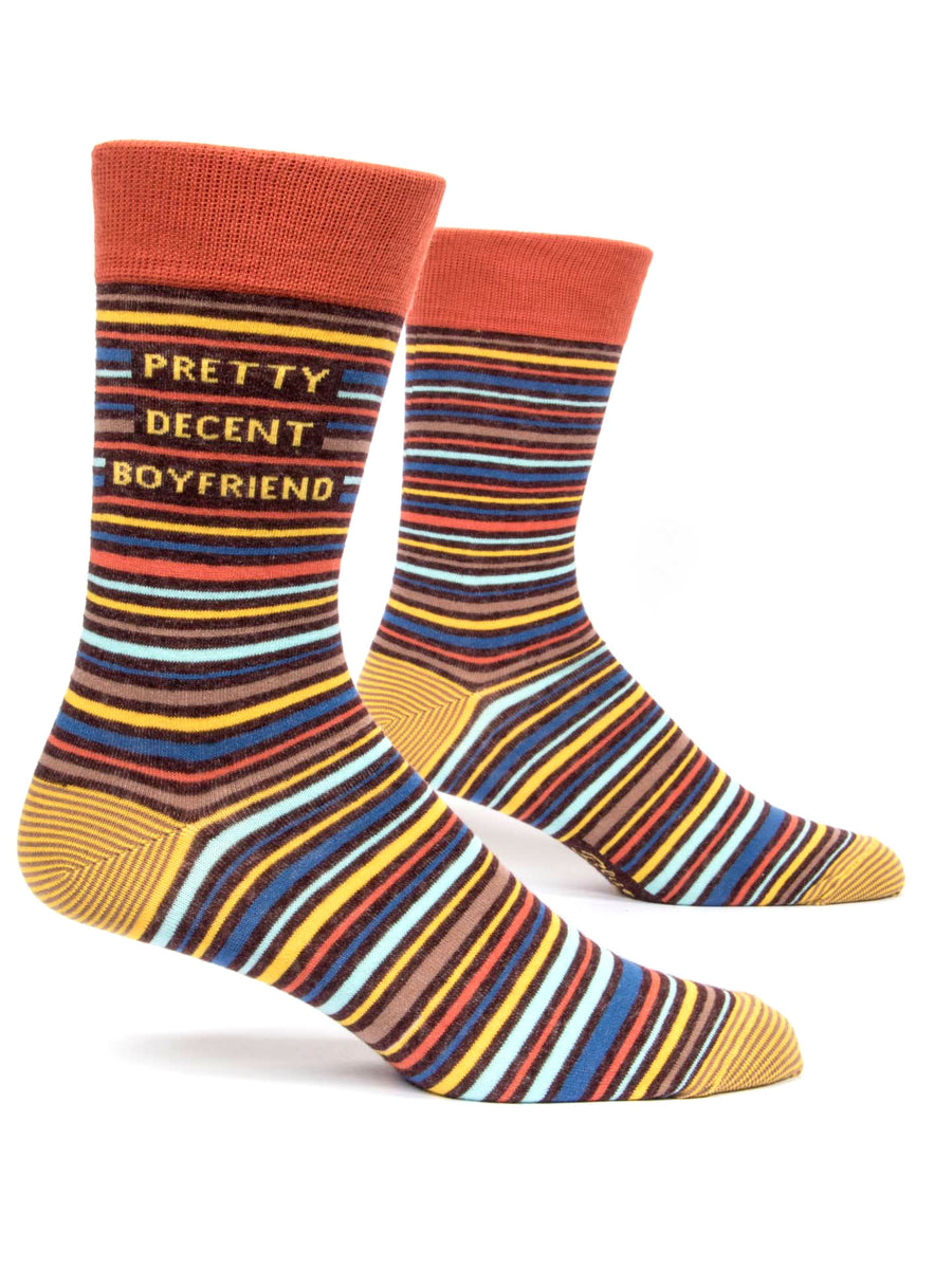 Introducing the Pretty Decent BF Men's Socks by Blue Q: These vibrant socks feature horizontal stripes in eye-catching colors such as orange, yellow, blue, and brown. Made from a comfortable cotton blend, they are designed with text on the calf reading "Pretty Decent Boyfriend" and finished off with a solid orange band at the top. Perfect for men's shoe collections.