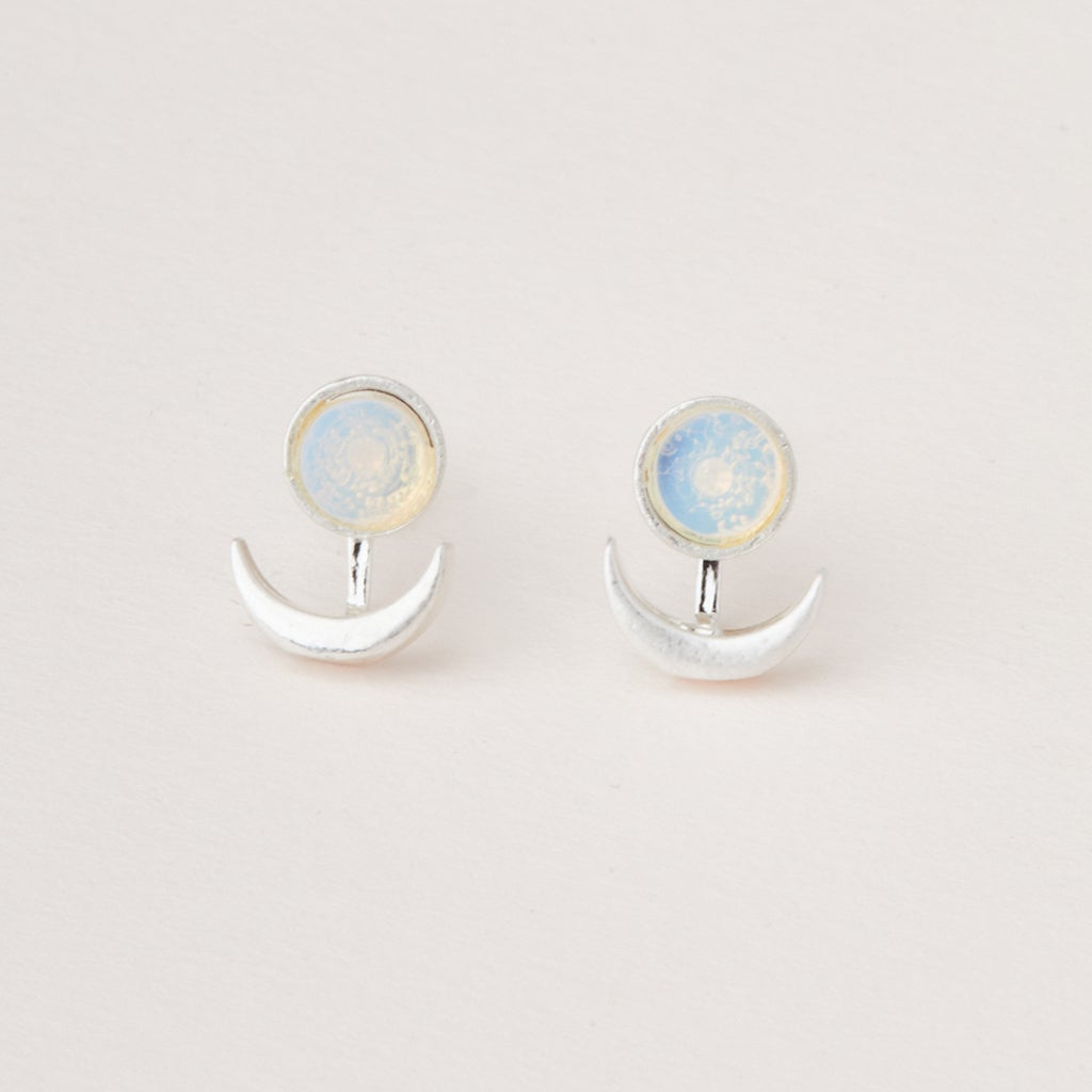 A pair of Scout Jewelry "Moon Phase Amazonite/Gold" earrings featuring an adjustable brass crescent ear jacket with a round opalescent semi-precious amazonite stone stud, set against a plain white background.