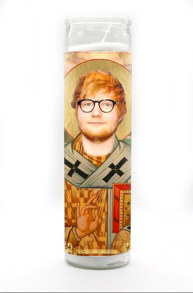 The Ed Sheeran Candle by BOBBYK BOUTIQUE showcases a prayer candle with a stylized image of a singer with glasses, red hair, and a beard, depicted in a classical religious icon style featuring ornate patterns and a halo.